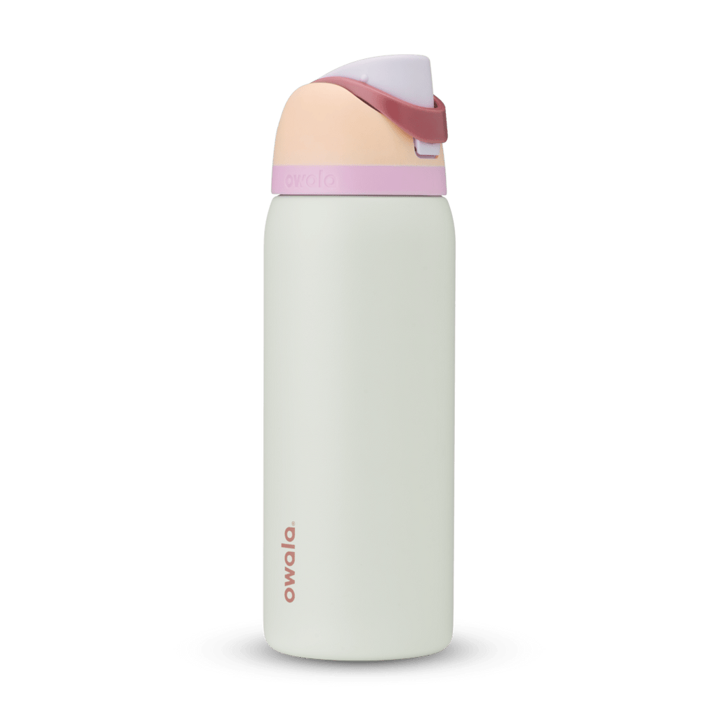 FreeSip 32oz in Coastal Mist, pale mint green body with peach flip cap, dusty rose carry loop, lavender accent band, and pink logo