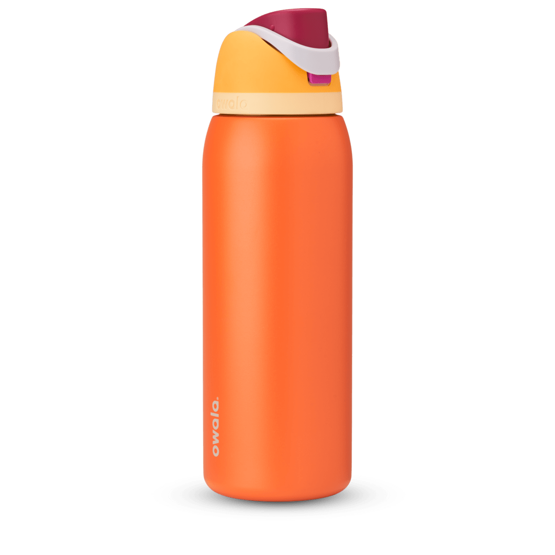 FreeSip 40oz in Citrus Crush, bright orange body with yellow flip cap, magenta carry loop, and cream accent band