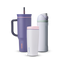 Owala All Day Bundle showing three bottles — a deep purple 40oz Tumbler with side handle, peach pink accent ring, and dark purple straw, a small white insulated cup with pink accent ring, and a white FreeSip with mint green accent band, lavender flip cap, and matching lavender carry loop