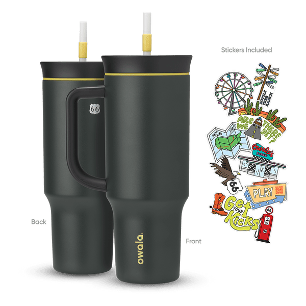 Great American Road Trip Tumbler 40oz in Route 66 (dark charcoal-black body and handle with yellow accent ring and white straw), back and front views shown with included Route 66-themed stickers featuring a Ferris wheel, motel signs, gas pump, and roadside icons