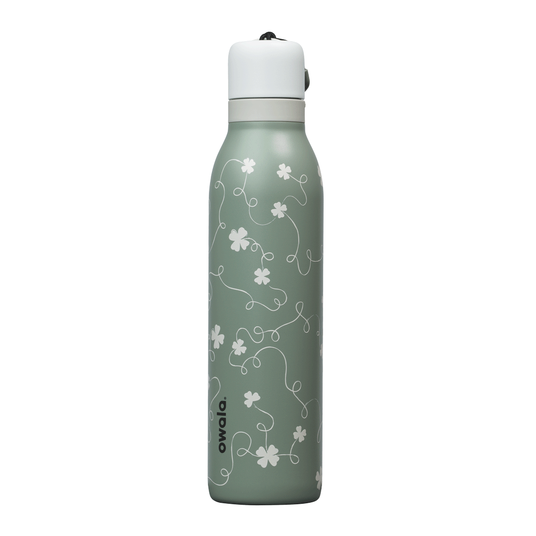 Owala RS: Clover Achiever FreeSip Twist 24oz bottle in sage green with subtle white four-leaf clover pattern; white twist-off lid; animated 360-degree spin view Main image