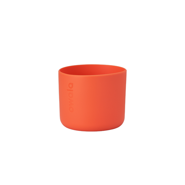 Owala Bottle Boot in bright tangerine orange silicone with tonal Owala logo, short cylindrical form sized for 16oz Kids' FreeSip bottles