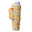 Animated mood board showing a FreeSip Tumbler 40oz in a multicolored geometric patchwork pattern of peach, mustard yellow, mint green, gray, and lavender shapes, with a peach orange side handle, light yellow lid, mint green lid accent ring, and lavender flip cap