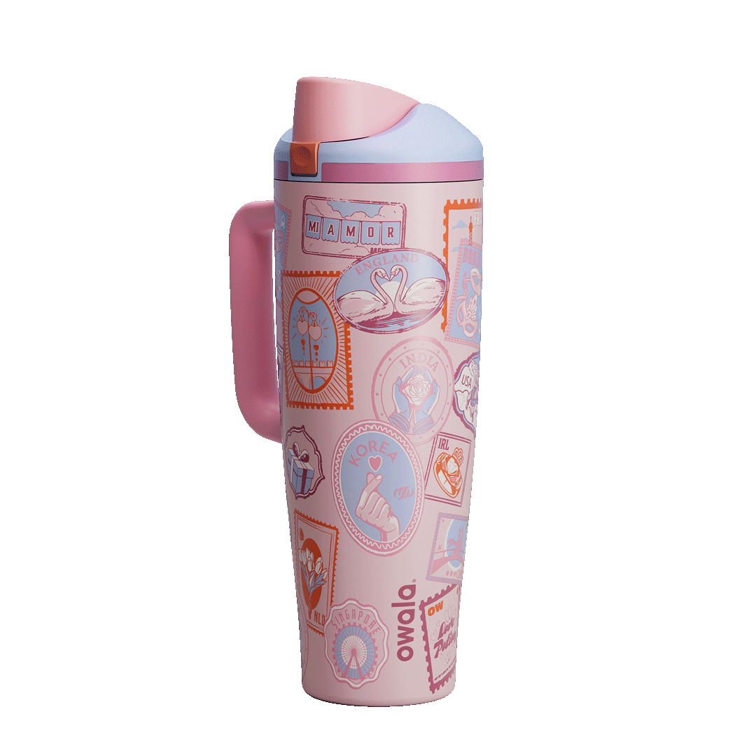 FreeSip Tumbler 40oz Sending Love; rotating view of blush pink handled tumbler with pastel illustrated stamp patches and pink flip cap Main image
