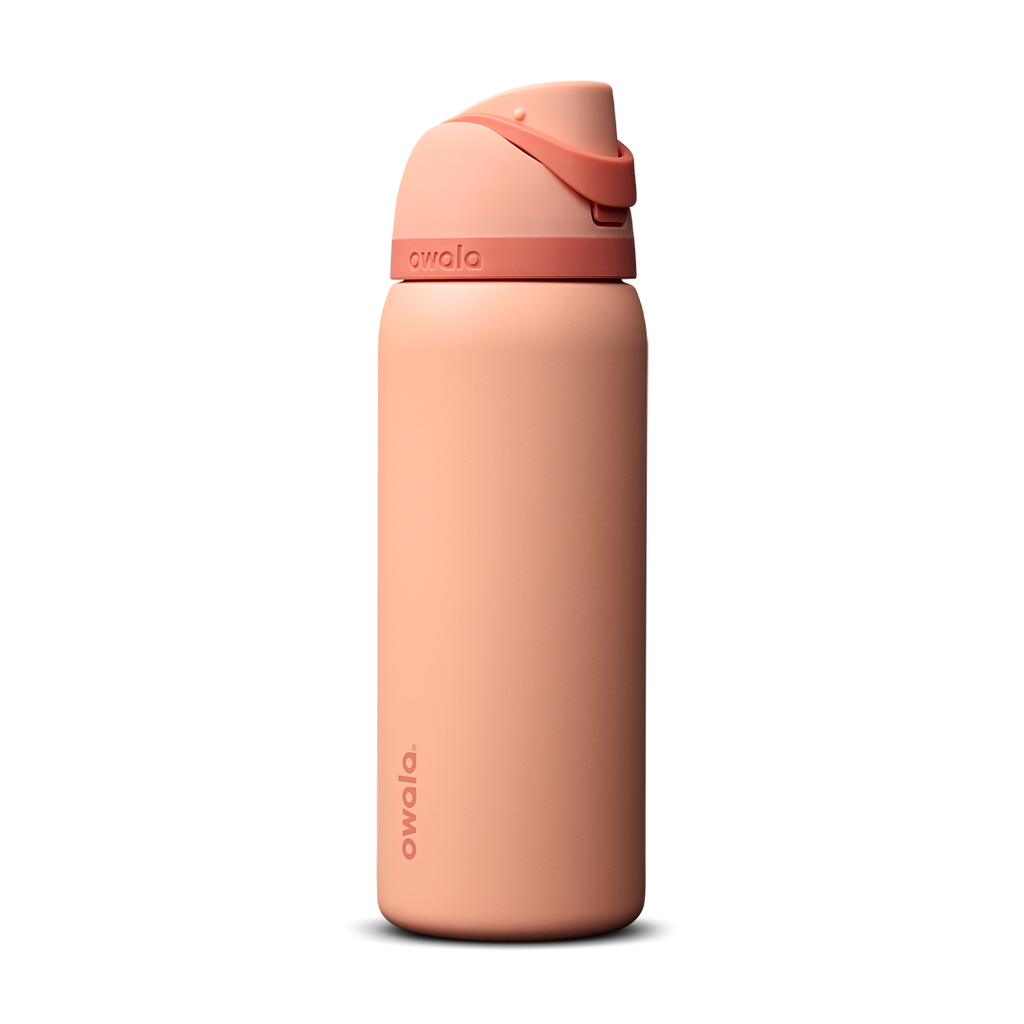 Owala FreeSip 32oz in Peach of Mind, soft coral peach insulated bottle with matching peach flip cap and carry loop