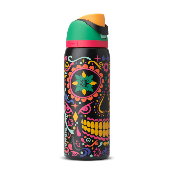 FreeSip 32oz in Sugar Skull, black body with colorful Day of the Dead sugar skull graphic in pink, yellow, green, and turquoise; green flip cap with orange detail, hot pink accent band on the lid; glows in the dark