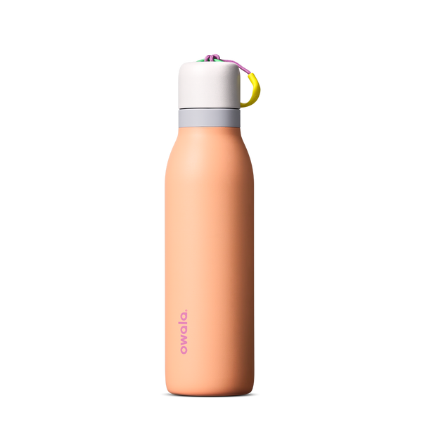 FreeSip Twist 18oz in Peachy Keen (soft coral-peach) with a light grey lid and multicolor loop accent, shown