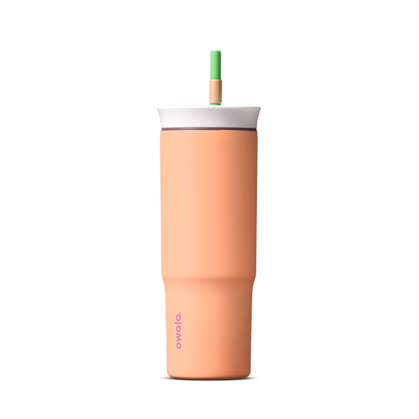 24oz Tumbler in Peachy Keen; matte peach-orange insulated tumbler with white lid and green straw, Owala wordmark on front