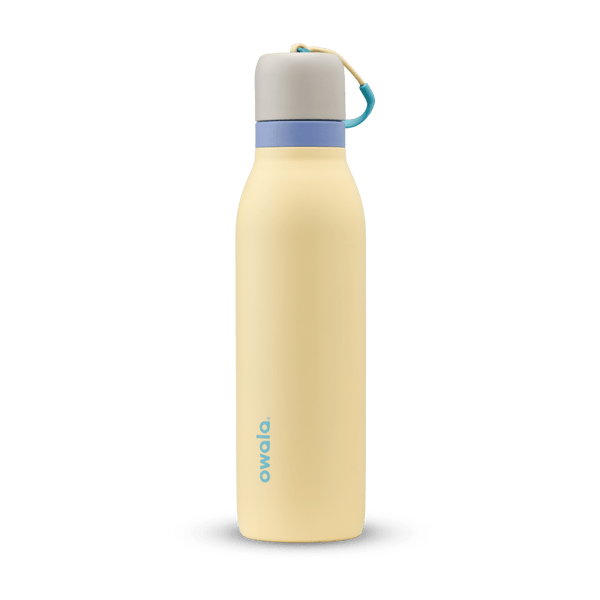 FreeSip Twist 18oz in Sunny Daze, pale yellow insulated water bottle with light gray twist cap, periwinkle blue twist cap accent band, and teal carry string with grip