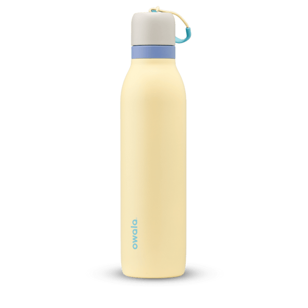 FreeSip Twist 24oz in Sunny Daze, pale yellow insulated water bottle with light gray twist cap, periwinkle blue twist cap accent band, and teal carry string with grip